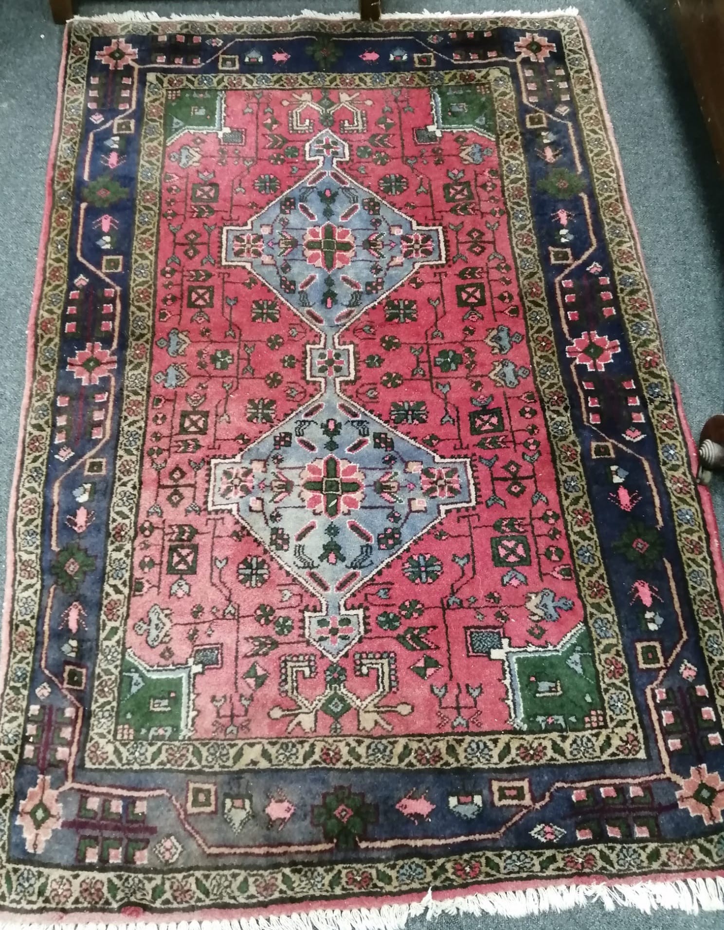 A Caucasian style red ground rug, 150 x 100cm